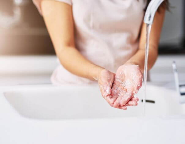 woman washing her hands with soap