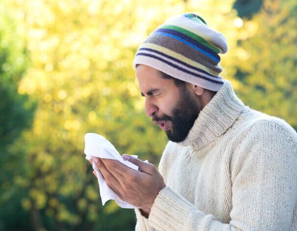 man sneezing allergies