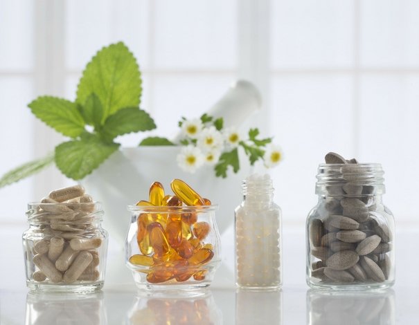 glass jars with supplements and vitamins of various colors and shape glass jars with supplements and vitamins