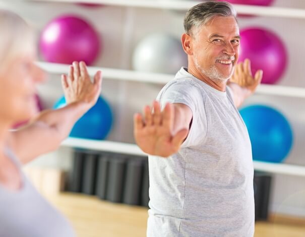 Senior man exercising in a class 