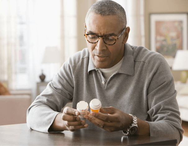 Man reading medication labels