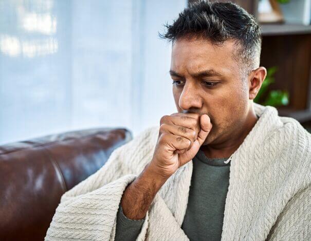 Man coughing in his hand